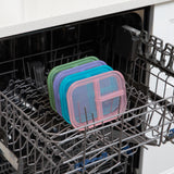 Four lids, including one from Bumkins Silicone Bento Box 3 Section: Green Jelly, sit in the top rack of an open dishwasher.