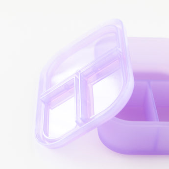 Close-up of Bumkins Silicone Bento Box 3 Section: Purple Jelly, with a leak-resistant lid and compartments, on a white background.