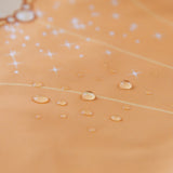 Close-up of water droplets on Bumkins Ruffle Apron Bib: Belle.