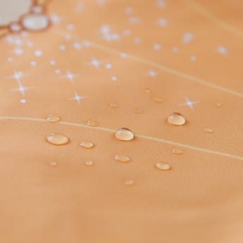 Close-up of water droplets on Bumkins Ruffle Apron Bib: Belle.