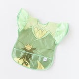 Bumkins Ruffle Apron Bib: Tiana lays flat on a white background.