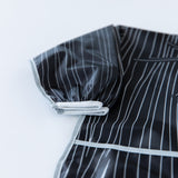 Close-up of a bib from Bumkins Snack In Character 3-Piece Set: Disney Everyday Is Halloween Jack on a white background; focus on the sleeve.