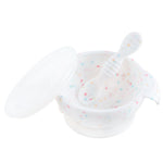 Bumkins Silicone First Feeding Set: Vanilla Sprinkle includes a white speckled bowl with secure suction base, matching spoon, and clear lid.