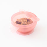 Bumkins Silicone First Feeding Set: Pink Jelly sits on a white background, filled with oatmeal and berries.
