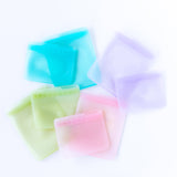 Bumkins Silicone Flat Reusable Bag 2 Pack, Blue lays among other similar bags sets on a white background.