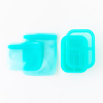 Bumkins Silicone Lunchtime 4-Piece Set in Blue Jelly: 3 turquoise bags and 2 matching bento boxes on white background.