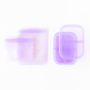 Two Bumkins Silicone Lunchtime 4-Piece Sets in Purple Jelly sit on a white background.