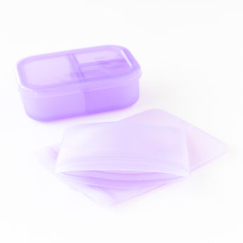 Bumkins Silicone Lunchtime 4-Piece Set in Purple Jelly includes a plastic container and two LFGB-grade silicone bags.