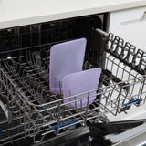 Bags from Bumkins Silicone Lunchtime 4-Piece Set: Purple Jelly sit in the top rack of an open dishwasher.