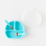A plate, lid, and toddler utensils from Bumkins On-The-Go Mealtime 6-Piece Set: Denim + Blue rest on a white background.