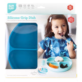 The Bumkins Silicone Grip Dish packaging shows a girl enjoying her meal with perfect toddler portions on a dark blue plate.