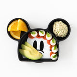Bumkins Silicone Grip Dish: Mickey Mouse holds caprese salad, sliced avocado, orange wedges, and chicken salad on a white background.