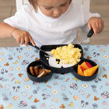 A child eats breakfast with Bumkins Grip Dish Essential 3-Piece Mealtime Set: Disney Mickey Mouse on a table covered by a blue patterned mat.