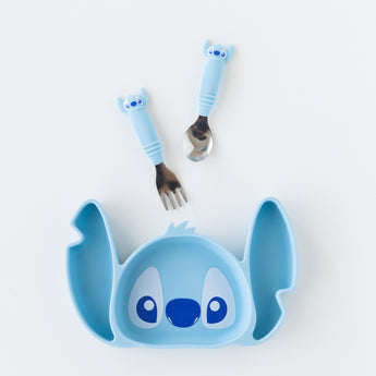 Bumkins Silicone Grip Dish: Stitch sits on a white background below toddler utensils with Stitch-shaped handles.