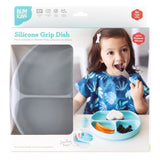 Toddler using the Bumkins Silicone Grip Dish: Gray with a suction base. Perfect plates for kids aged 6+ months.