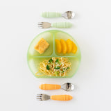 Bumkins Silicone Grip Dish: Green Jelly holding noodles, broccoli, orange slices & bread next to two utensil sets on a white background.