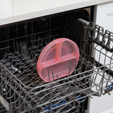Bumkins Silicone Grip Dish: Pink Jelly sits in the top rack of an open dishwasher.