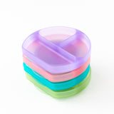 A vibrant stack of dishes on a white background, with Bumkins Silicone Grip Dish: Purple Jelly on top.