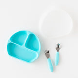 Bumkins Grip Dish Essential Toddler 4-Piece Mealtime Set in blue, includes plate, fork, spoon, and white cover.