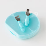 The Bumkins Grip Dish Essential Toddler 4-Piece Set in blue includes a divided plate, fork, and spoon with chunky handles.