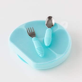 The Bumkins Grip Dish Essential Toddler 4-Piece Set in blue includes a divided plate, fork, and spoon with chunky handles.