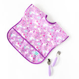 Bumkins Spoon + Fork: Lavender lays next to a purple unicorn-patterned bib on a white background.