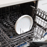 Bumkins Silicone Grip Plate: Vanilla Sprinkle sits in the top rack of an open dishwasher.