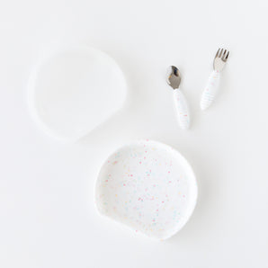 Bumkins Grip Plate Essential 4-Piece Mealtime Set in Vanilla Sprinkle: plate, spoon, fork & bib with colorful speckles.