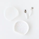 Bumkins Grip Plate Essential 4-Piece Mealtime Set in Vanilla Sprinkle: plate, spoon, fork & bib with colorful speckles.