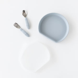Bumkins Grip Plate Essential 4-Piece Mealtime Set in gray, with matching fork, spoon, and translucent silicone pouch.