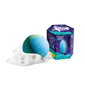 A plant-based blue/green bath bomb with white foam rests next to a purple/blue hexagonal Galaxy box by Loot Toys.
