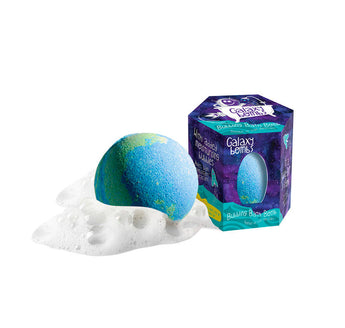 A plant-based blue/green bath bomb with white foam rests next to a purple/blue hexagonal Galaxy box by Loot Toys.
