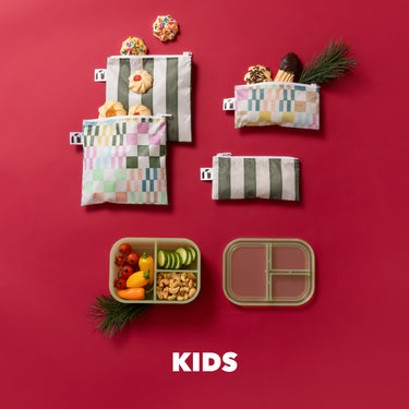 Colorful snack bags and lunch containers with food on a red background, with the word KIDS at the bottom.