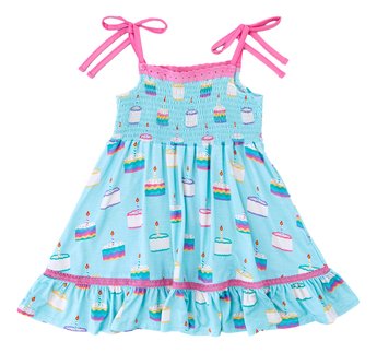 Harlow Smocked Birdie Dress by Birdie Bean in blue with pink straps and cake patterns, made from comfy bamboo viscose.