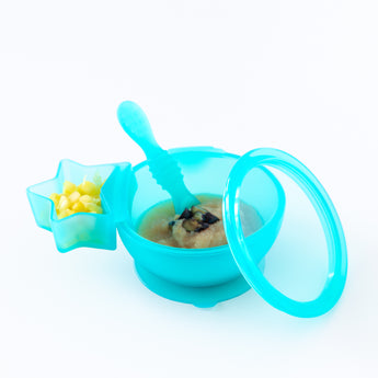 A blue bowl with applesauce and a Bumkins Silicone Little Dipper Combo 2 Pack: Aqua Jelly with fruit are displayed on a white background.