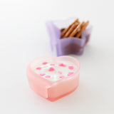 Bumkins Silicone Little Dipper Combo 2 Pack: Magenta Jelly on a white background: pink heart with yogurt, and purple star with pretzels.