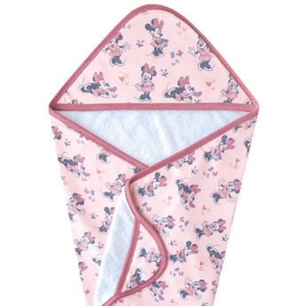 Pink baby hooded towel in terry cloth with cartoon prints, hearts, and pink trim. Lined in soft fabric. Copper Pearl’s Minnie Mouse towel.