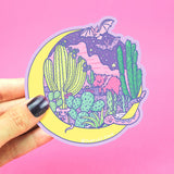 Turtle Soups Desert Moon vinyl sticker: cacti, fox, bats & snake in a yellow crescent, pink background. Waterproof & scratch-resistant.