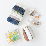 Bumkins The Outfit Organizer Essential 5-Piece Set: Palm Daze holds clothes, shoes, toiletries, and keys on a white background.