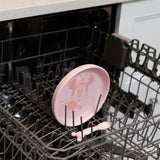 Bumkins Silicone Plate + Spoon Set: Disney Minnie Mouse sits in the top rack of an open dishwasher.