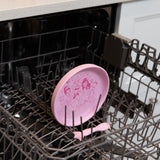 Bumkins Silicone Plate + Spoon Set: Disney Princess sits in the top rack of an open dishwasher.