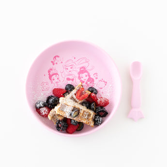 Bumkins Silicone Plate + Spoon Set: Disney Princess filled with waffles, berries & powdered sugar on a white background.