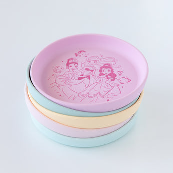 Bumkins Silicone Plate + Spoon Set: Disney Princess is stacked on top of other similar plates on a white background.