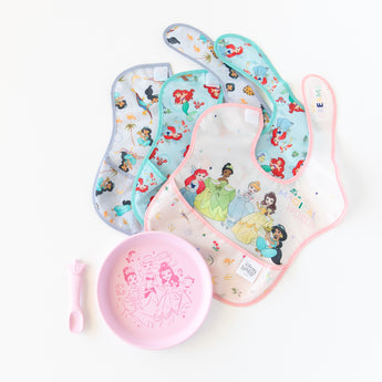 Bumkins Silicone Plate + Spoon Set: Disney Princess is displayed on a white background with three waterproof bibs.