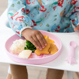 A child reaches for a dino nugget from Bumkins Silicone Plate + Spoon Set: Disney Princess with mashed potatoes and broccoli.