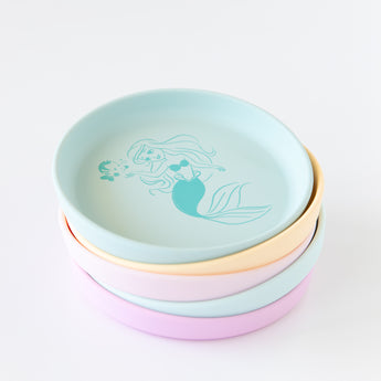 Bumkins Silicone Plate + Spoon Set: Disney Princess Ariel is stacked on top of other similar plates on a white background.