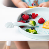 Bumkins Silicone Plate + Spoon Set: Disney Princess Ariel, filled with broccoli, berries, and a pancake, sits on a highchair tray.
