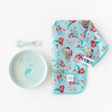 Bumkins Silicone Plate + Spoon Set: Disney Princess Ariel sits next to a waterproof bib on a white background.