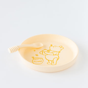 Bumkins Silicone Plate + Spoon Set: Disney Winnie the Pooh rests on a white background.