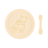 Bumkins Silicone Plate + Spoon Set: Disney Winnie the Pooh includes a silicone plate with a Winnie the Pooh illustration and a matching spoon.